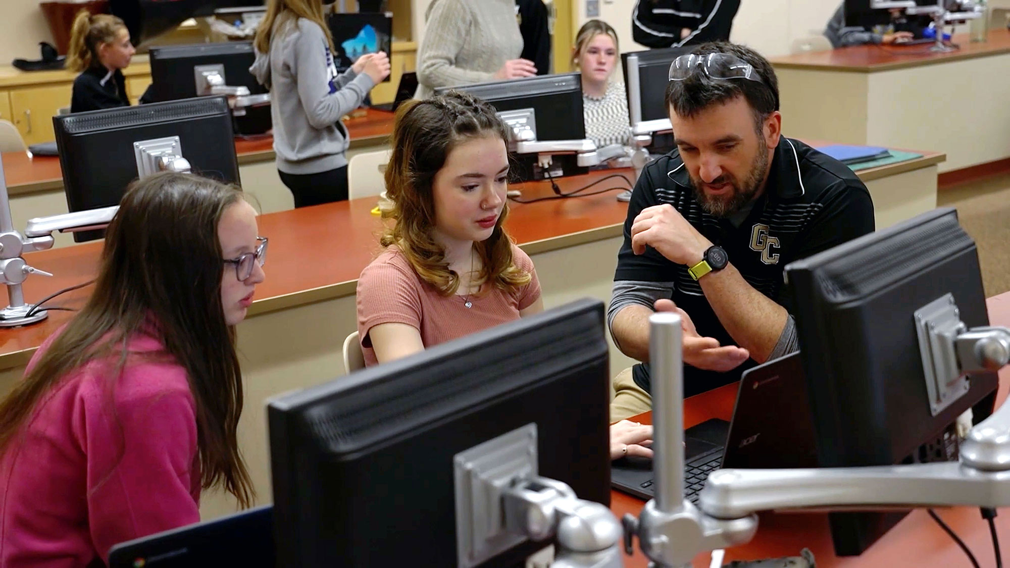 students and teacher collaborate in class