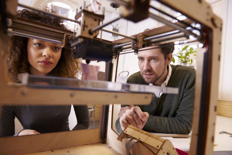 Two,Designers,Working,With,3d,Printer,In,Design,Studio